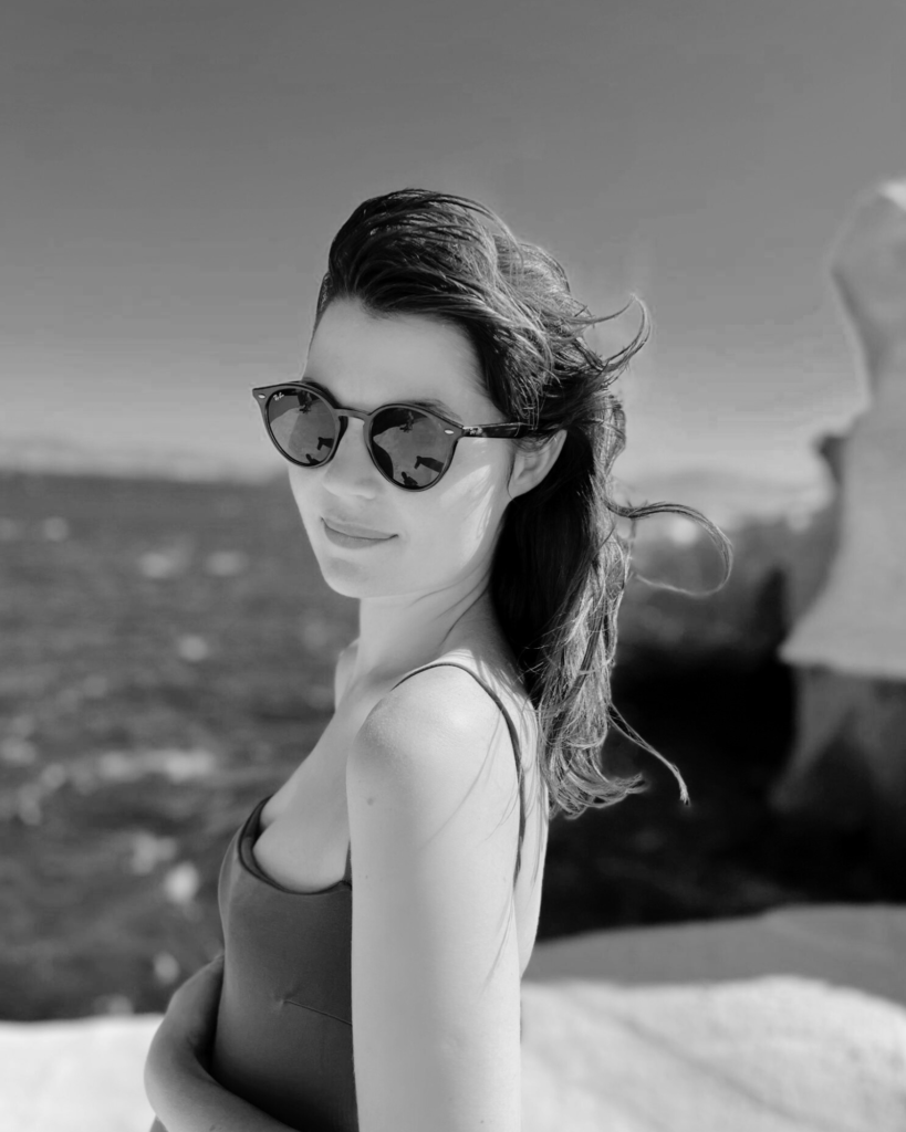 black and white photo of a girl on beautiful beach